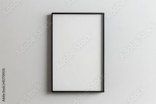 
A black picture frame on a white wall provides a perfect blank canvas for displaying artwork, photos, or posters in a modern and minimalist setting