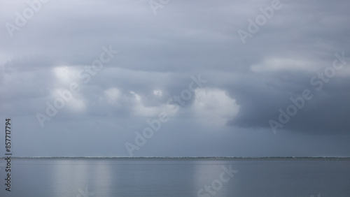 Dark storm clouds over a quiet ocean