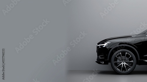 Bold black SUV on the right, plain grey backdrop with left side space for text, perfect for luxury car marketing visuals. photo