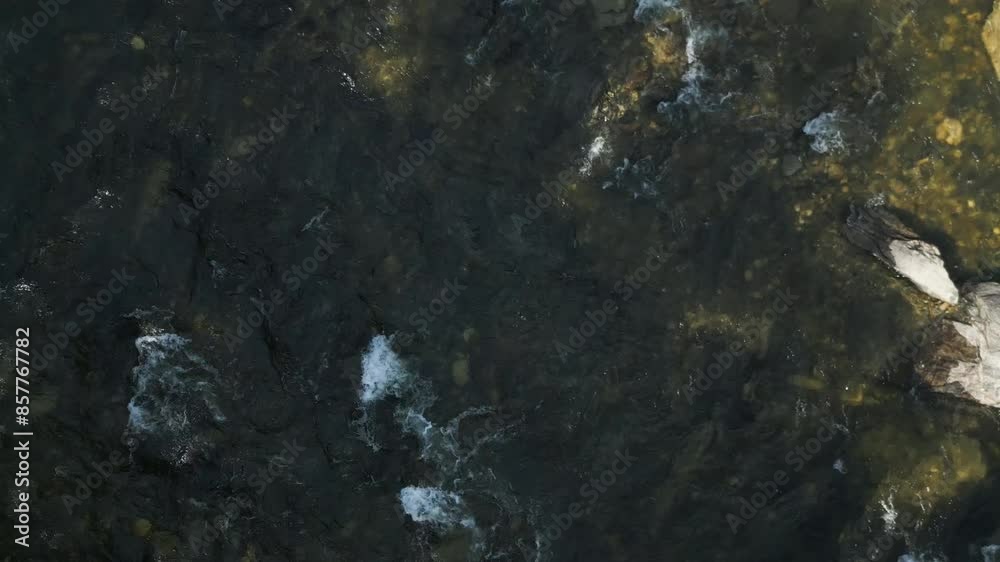 Stream Rushing On A Rocky Riverbed In The Wilderness. Aerial Shot Stream Rushing On A Rocky Riverbed In The Wilderness. Aerial Shot