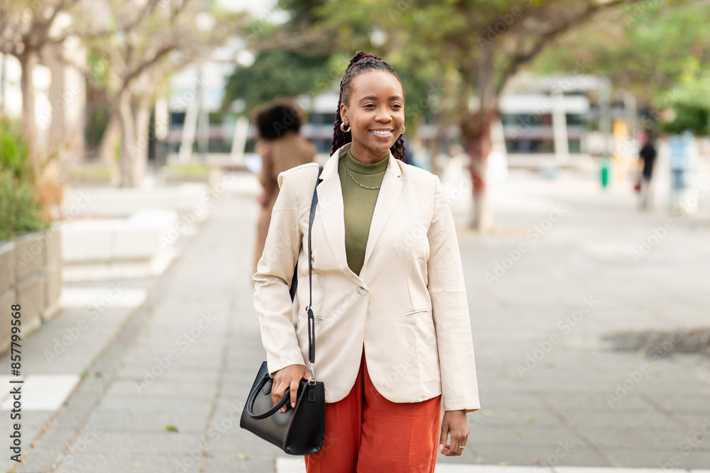 Fototapeta premium Confident Black Woman Entrepreneur Outdoors in Professional Business Attire