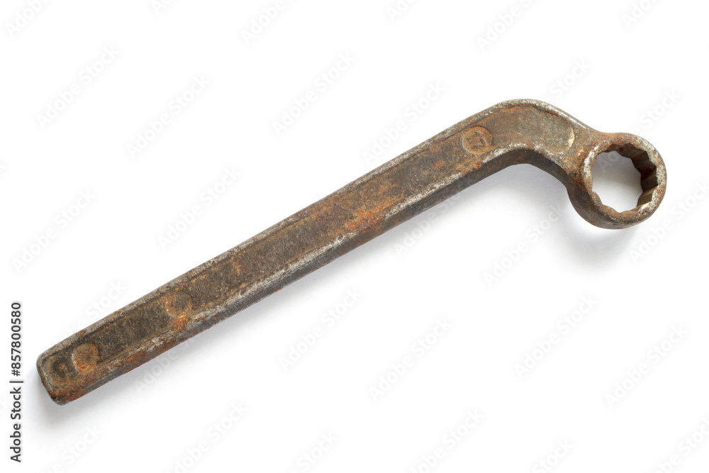 A hook wrench on a white background. An old rusty wrench. A hook wrench on a white background. An old rusty wrench.