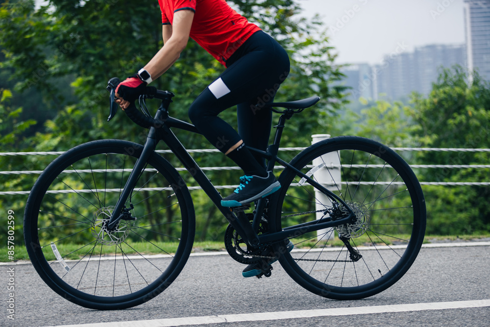 Fototapeta premium Asian woman cycling on summer trail