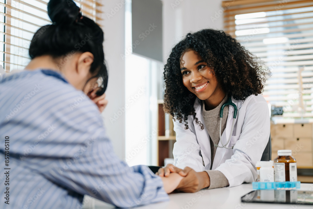 Asia female doctor using clipboard is delivering great news talk discuss results or symptoms with female patient Asia female doctor using clipboard is delivering great news talk discuss results or symptoms with female patient