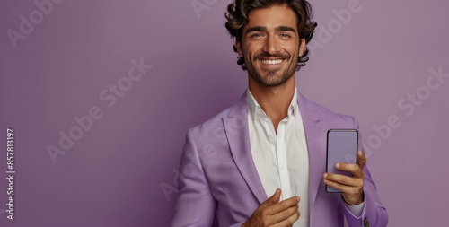 Smiling Man Holding Smartphone Against Purple Background