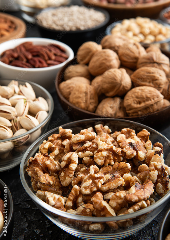 Raw walnuts and cashew with almonds and peanuts with organic nuts and seed in various assorted bowls.Macro Raw walnuts and cashew with almonds and peanuts with organic nuts and seed in various assorted bowls.Macro