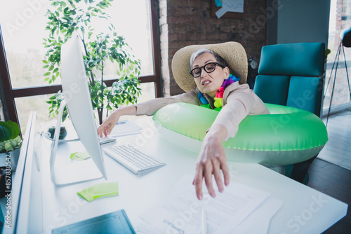 Photo of attractive sad age lady agent dressed formal shirt tired working modern gadget dreming trip indoors workplace workstation loft photo