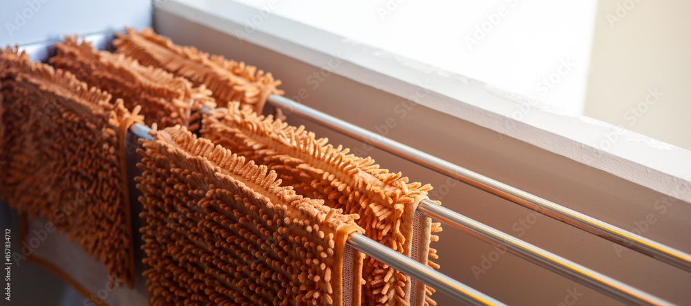 Bath towel on the drying rack after cleaning. Treatment of fabric. Bath towel on the drying rack after cleaning. Treatment of fabric.