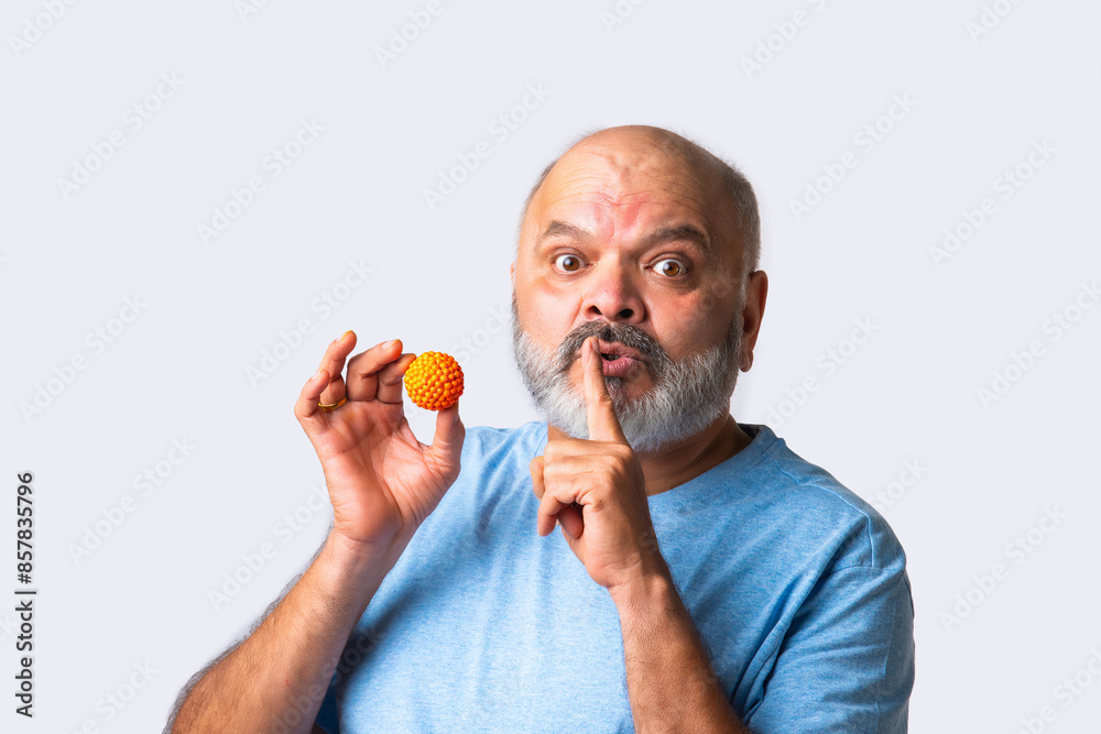 Indian asian senior old elderly man eating sweet bundi laddu or laddoo eating sweet bundi laddu or Boondi Laddoo Indian asian senior old elderly man eating sweet bundi laddu or laddoo eating sweet bundi laddu or Boondi Laddoo