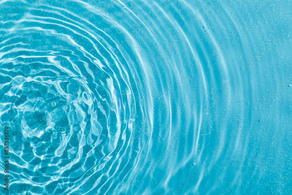 drops on water with circles on a blue background drops on water with circles on a blue background