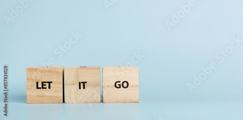 Wooden cubes with inscriptions Let It Go on a blue background