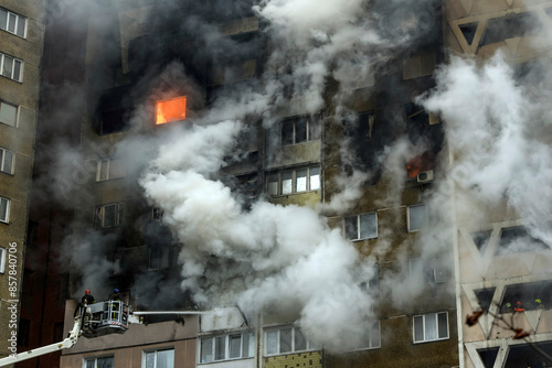 Firefighters are working at the site of a burning residential high-rise building that was damaged by a massive Russian missile strike in Kyiv, Ukraine, on February 7, 2024