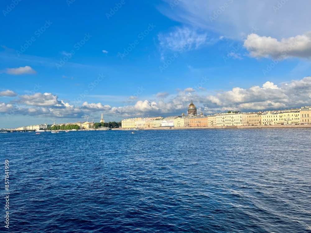 Fototapeta premium Fantastic white clouds at the city river, city river view, summer day