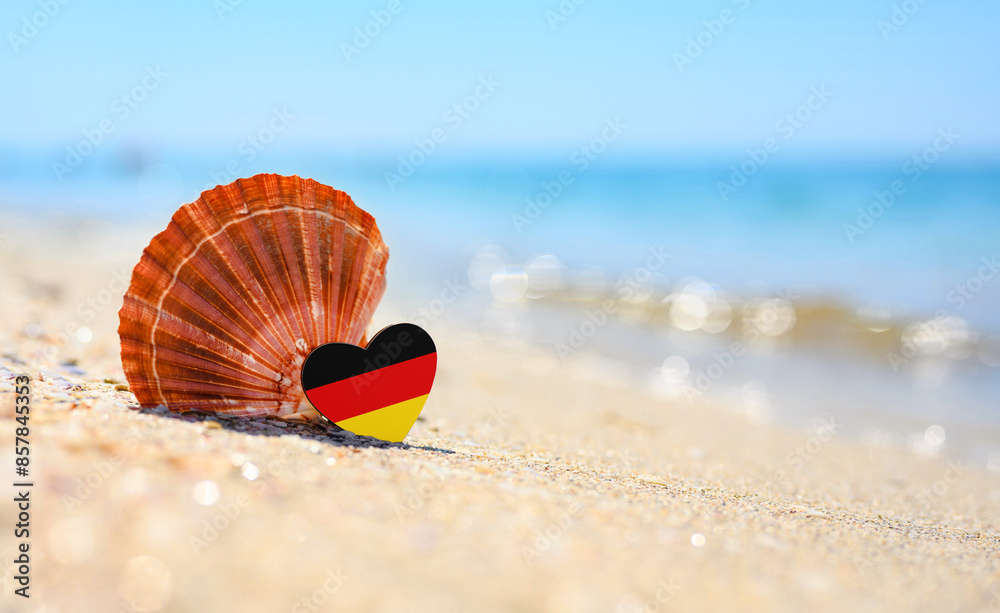 Flag of Germany in the shape of a heart and a large shell. A wonderful seaside resort. Flag of Germany in the shape of a heart and a large shell. A wonderful seaside resort.