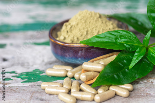 Herbal capsules of Paniculata in wooden spoon