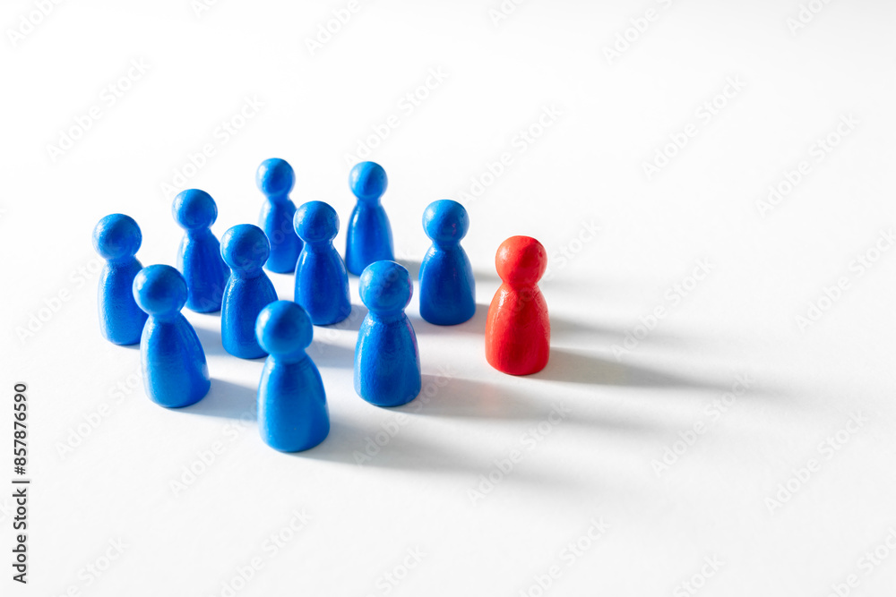 Leadership blue wooden business team with one red pawn person standing out from the crowd Leadership blue wooden business team with one red pawn person standing out from the crowd