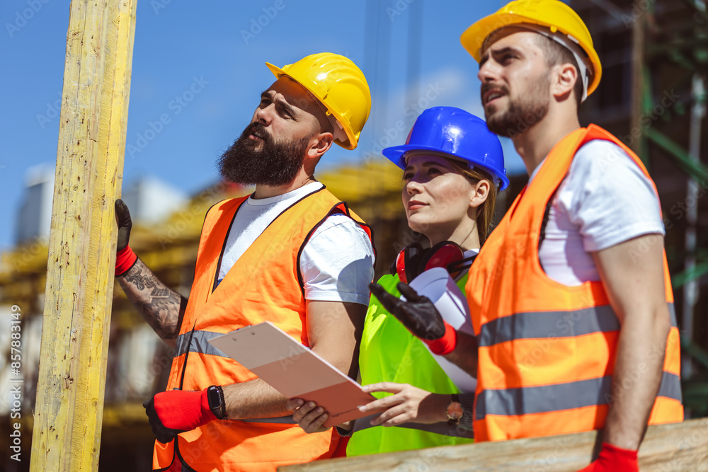 Two construction workers carrying bars at a building site - people at work concepts inside the building. Two construction workers carrying bars at a building site - people at work concepts inside the building.