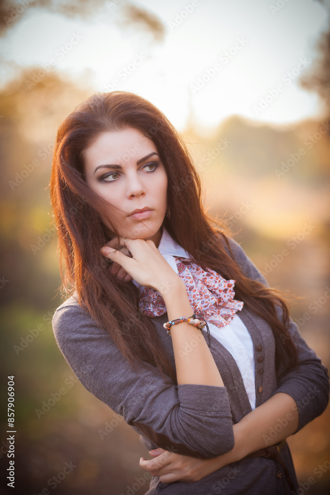 Fototapeta premium Autumn Beauty: Brunette Portrait Amidst Nature's Splendor