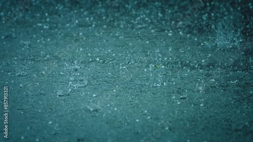 Spectacular summer hailstorm. Hailstones falling in a rain puddle