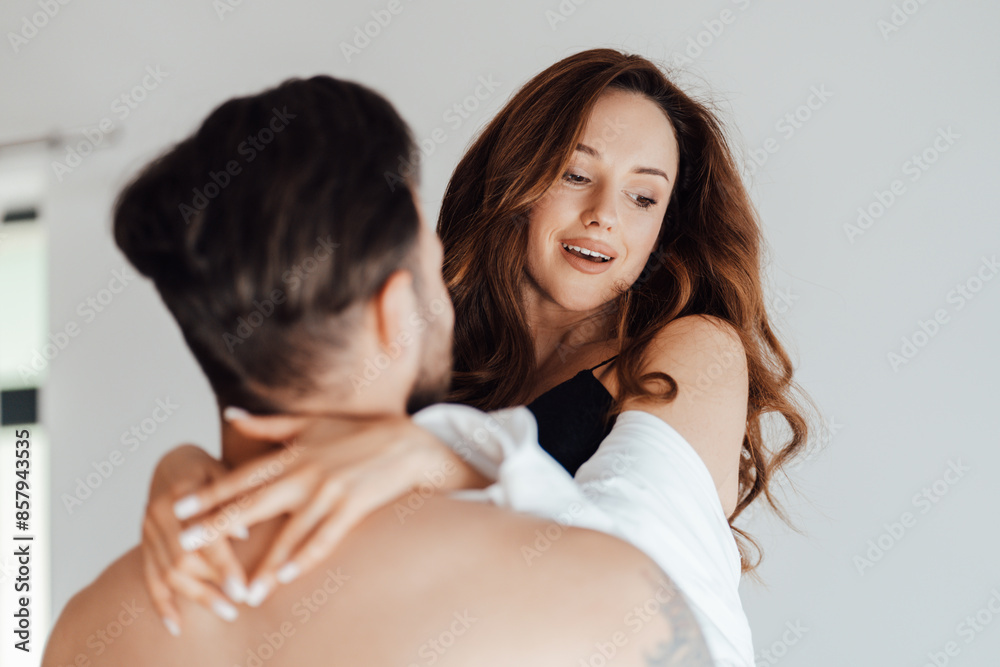 Happy playful beautiful young woman in sexy lingerie hugging man with passion Happy playful beautiful young woman in sexy lingerie hugging man with passion