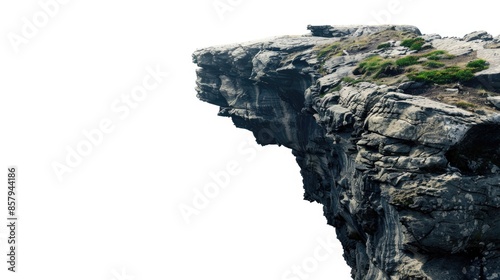 A person standing at the edge of a cliff with a vast landscape in the background