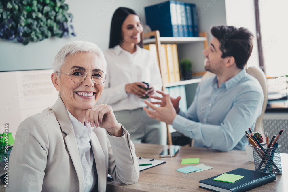 Photo of two employees mature boss woman corporate office team meeting professional collaborating working together in modern workplace Photo of two employees mature boss woman corporate office team meeting professional collaborating working together in modern workplace