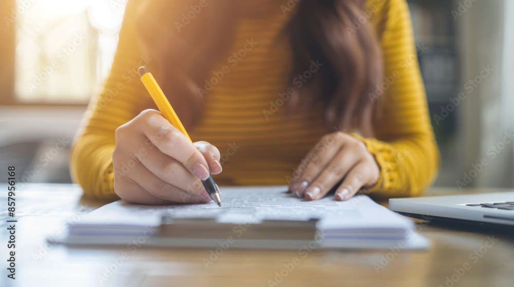 woman using a pencil to write on paper. Modern businesswoman's creativity at work in the office, technology and communication to bring ideas to life. woman using a pencil to write on paper. Modern businesswoman's creativity at work in the office, technology and communication to bring ideas to life.