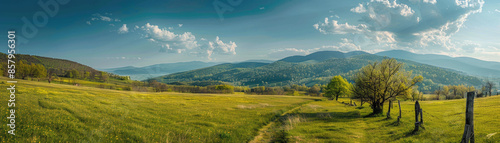 A panoramic view of the beautiful countryside on a sunny afternoon. landscape wonderful springtime scenery in the mountains, with a grassy field and rolling hills, a picturesque rural scenery.