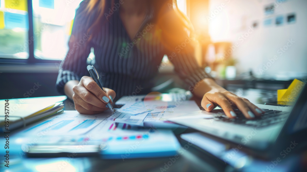 Fototapeta premium Businesswoman analyzing investment charts with laptop. Accounting. Woman workplace using technology finance analysis. Business strategy planning office. Corporate accountant working financial report.