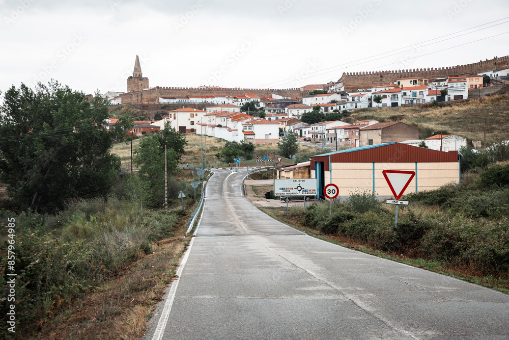 Naklejka premium a wet paved road with a view to Galisteo town, province of Caceres, Extremadura, Spain
