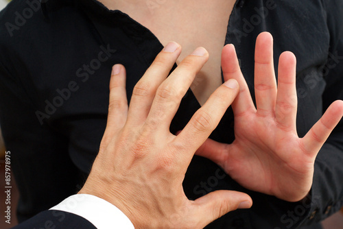 The woman is tactfully avoiding unwanted touch, asserting her boundaries and protecting her space