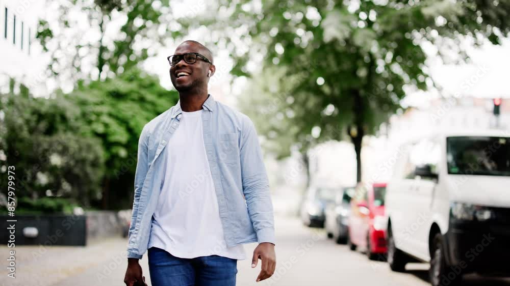young Caucasian businessman walking through a busy city street