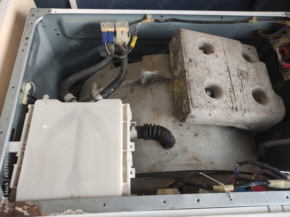 Old washing machine drum without top cap with powder container and counterweight inside