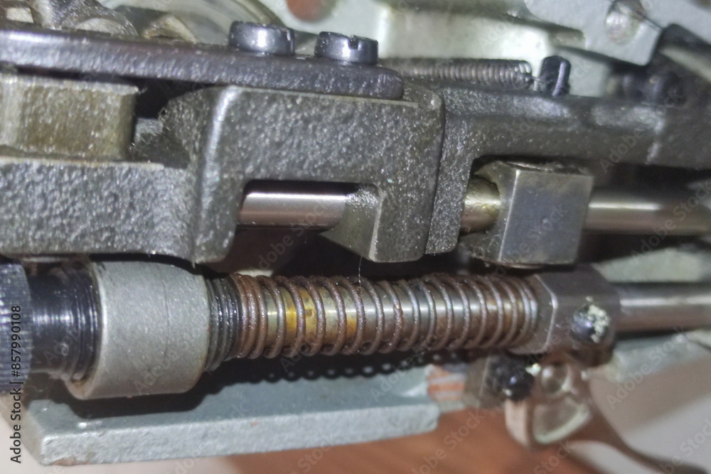 Old sewing machine spool drive rod mechanism closeup