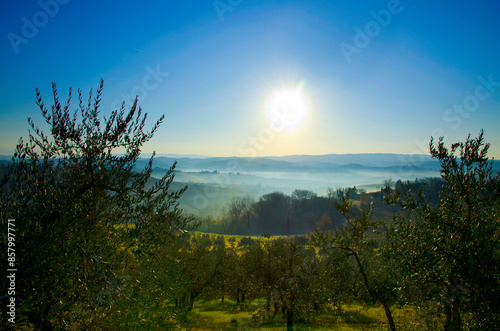 Panoramic View over the Foggy Landscape with Blue Clear Sky in a Sunny Day in Tuscany, Italy.