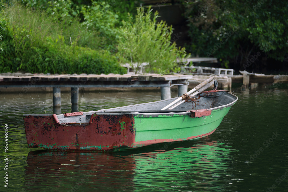 LANDSCAPE BY THE LAKE - Small old rowing boat on the lake LANDSCAPE BY THE LAKE - Small old rowing boat on the lake
