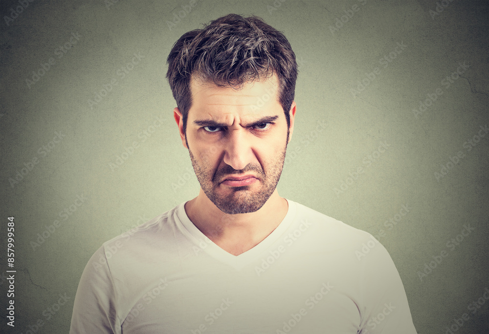 Closeup portrait of an angry grumpy young man Closeup portrait of an angry grumpy young man