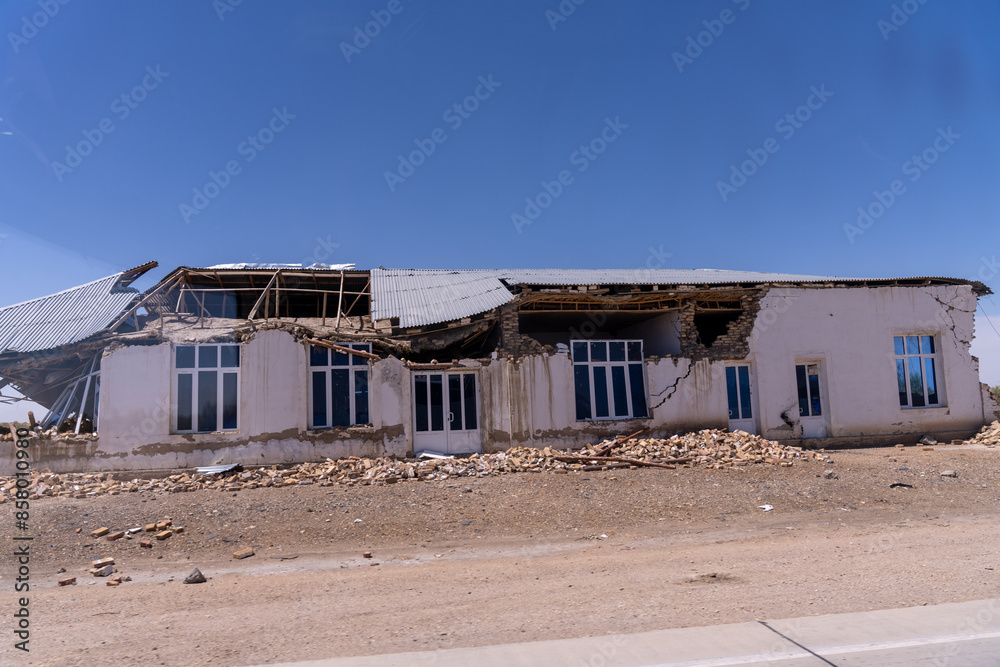 A house is in ruins with a lot of debris and rubble. The house is in a desert area A house is in ruins with a lot of debris and rubble. The house is in a desert area