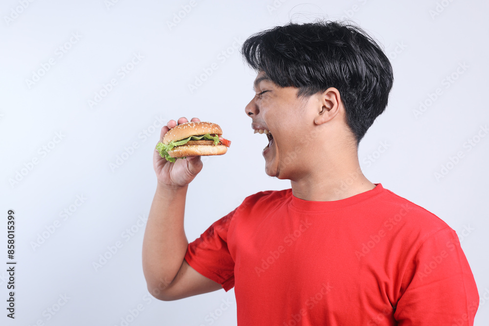 POV Young Asian Man Excited To Eating Burger Isolated On White Background POV Young Asian Man Excited To Eating Burger Isolated On White Background