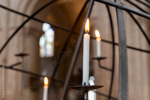 Tablou pe pânză Christian votive prayer candles burning metal globe stand in Norwich Cathedral