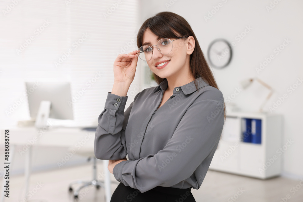 Portrait of smiling secretary wearing glasses in office Portrait of smiling secretary wearing glasses in office