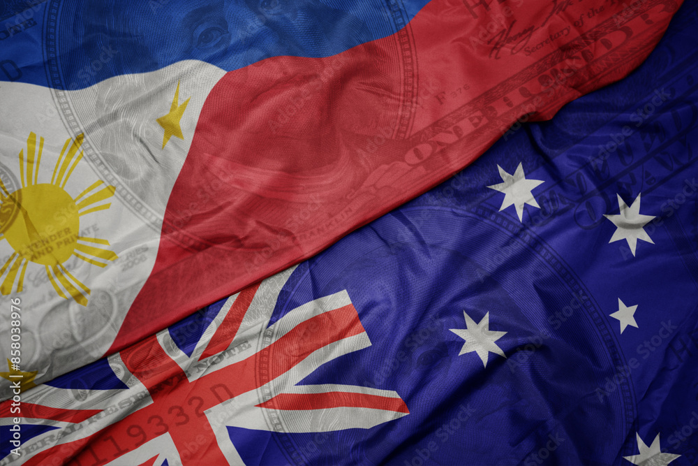 waving colorful flag of philippines and national flag of australia on the dollar money background. finance concept. waving colorful flag of philippines and national flag of australia on the dollar money background. finance concept.