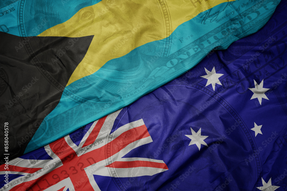 waving colorful flag of bahamas and national flag of australia on the dollar money background. finance concept. waving colorful flag of bahamas and national flag of australia on the dollar money background. finance concept.