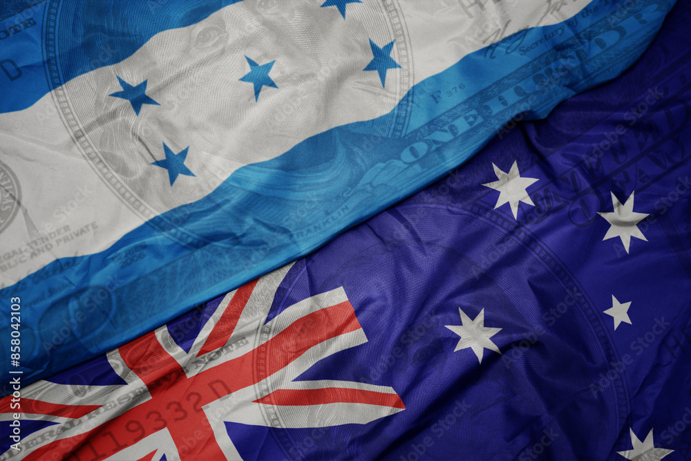 waving colorful flag of honduras and national flag of australia on the dollar money background. finance concept. waving colorful flag of honduras and national flag of australia on the dollar money background. finance concept.