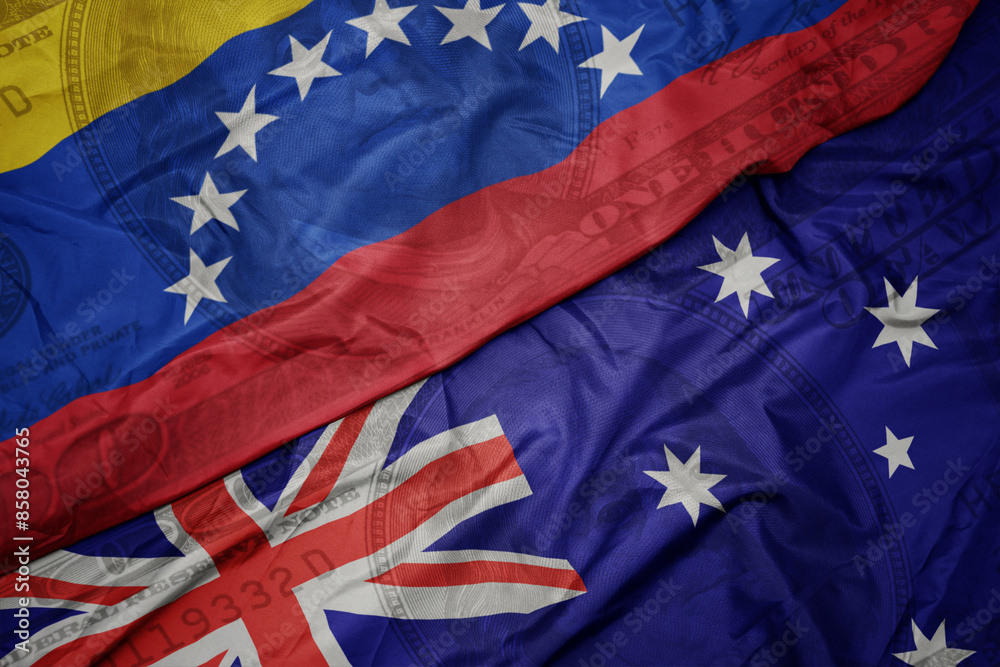 waving colorful flag of venezuela and national flag of australia on the dollar money background. finance concept. waving colorful flag of venezuela and national flag of australia on the dollar money background. finance concept.