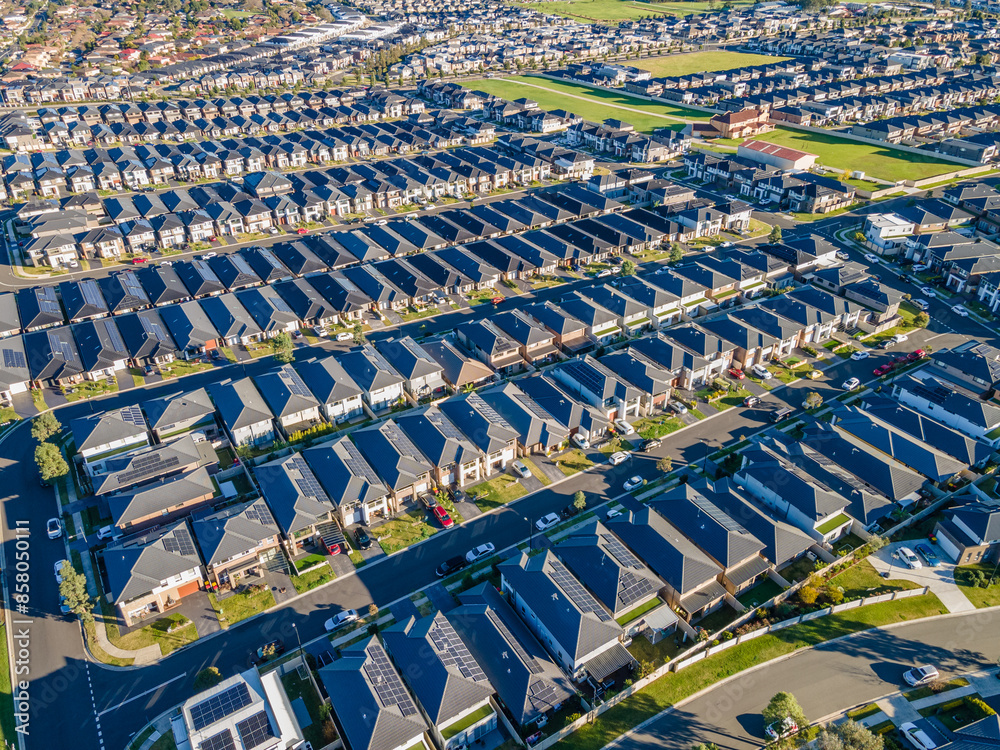 Fototapeta premium Aerial drone view of The Ponds in the North West of Sydney, NSW Australia on a sunny morning in June 2024 showing the densely packed homes and housing density 