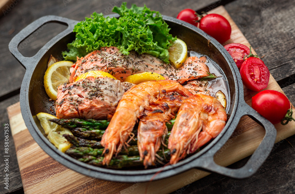 Healthy baked salmon steaks with greens and asparagus in a black cast iron skillet. A delicious low-carb breakfast. Healthy baked salmon steaks with greens and asparagus in a black cast iron skillet. A delicious low-carb breakfast.