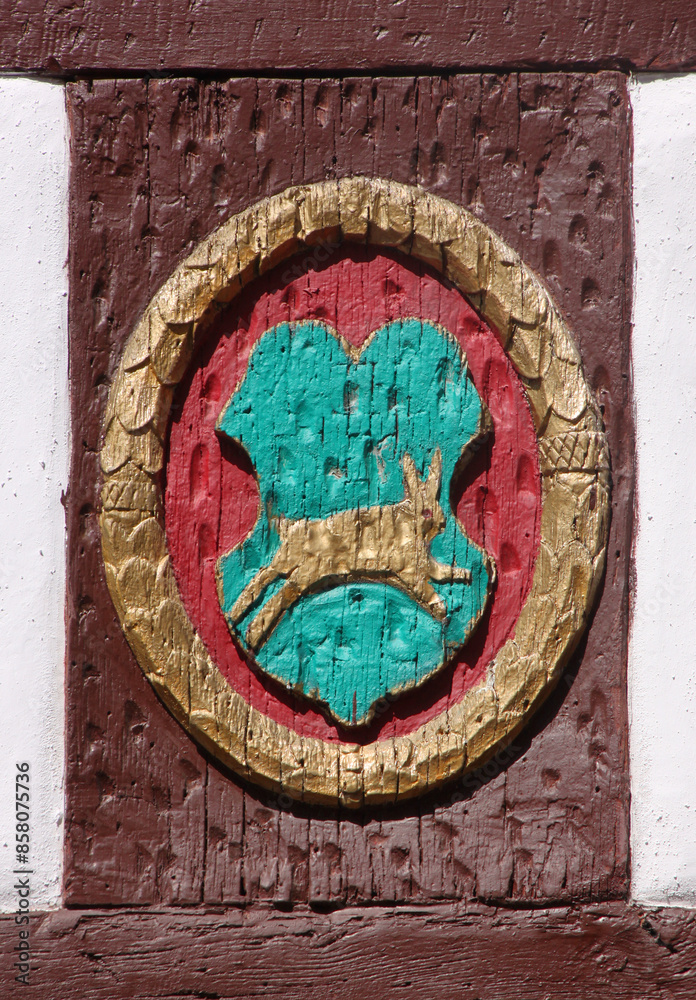 Oval rabbit coat of arms decoration on a wooden half-timbered facade in the medieval village of Zeltingen-Rachtig, Mosel region in Germany Oval rabbit coat of arms decoration on a wooden half-timbered facade in the medieval village of Zeltingen-Rachtig, Mosel region in Germany