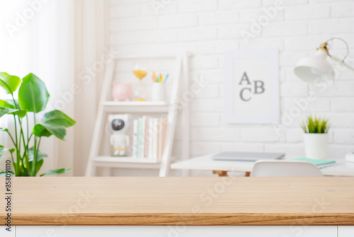 Fotografie Cropped shot of wooden table with copy space in blurred study room