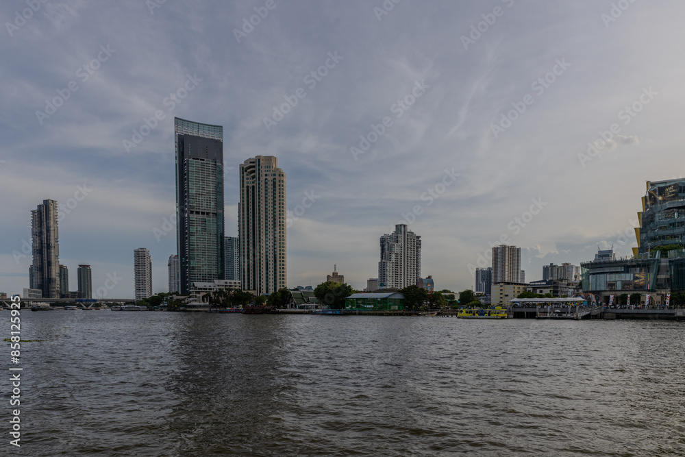 Fototapeta premium Wednesday 26 June 2024 BKK high rise towers building residential apartments and commercial buildings on Chao Phraya River Bangkok Thailand